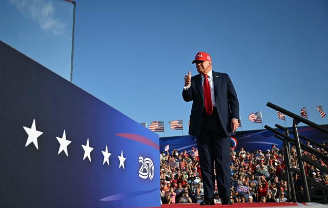 US President Donald Trump gestures as he steps on stage to deliver remarks at the Salute to America Celebration at the Iowa State Fairgrounds in Des Moines on July 3, 2025. (Photo by ANDREW CABALLERO-REYNOLDS / AFP)