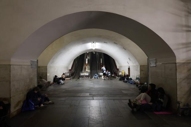People take shelter over night in an underground subway station during missile strikes in Kyiv on July 4, 2025, amid the Russian invasion of Ukraine. US President Donald Trump said he made no progress with Vladimir Putin on ending the Ukraine war in a call on July 3, as the Kremlin insisted the Russian president would stick to his aims in the conflict. (Photo by Barbara WOJAZER / AFP)