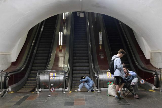 People take shelter over night in an underground subway station during missile strikes in Kyiv on July 4, 2025, amid the Russian invasion of Ukraine. US President Donald Trump said he made no progress with Vladimir Putin on ending the Ukraine war in a call on July 3, as the Kremlin insisted the Russian president would stick to his aims in the conflict. (Photo by Barbara WOJAZER / AFP)