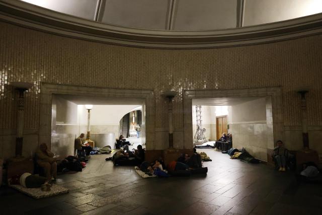 People take shelter over night in an underground subway station during missile strikes in Kyiv on July 4, 2025, amid the Russian invasion of Ukraine. US President Donald Trump said he made no progress with Vladimir Putin on ending the Ukraine war in a call on July 3, as the Kremlin insisted the Russian president would stick to his aims in the conflict. (Photo by Barbara WOJAZER / AFP)