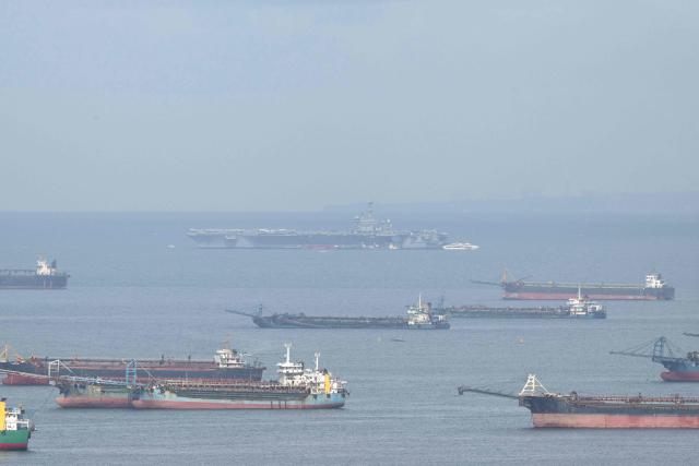 This photo shows a general view of US aircraft carrier USS George Washington (CVN-73) moored at Manila Bay in Manila on July 4, 2025. The nuclear-powered US carrier George Washington arrived off the Philippine capital for a port visit, as the two allies increase defence cooperation aimed at contesting China's sweeping claims in the South China Sea. (Photo by Ted ALJIBE / AFP)