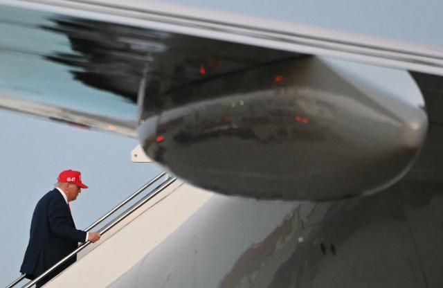 US President Donald Trump boards Air Force One as he departs Des Moines International Airport, Iowa on July 3, 2025. Trump was in Iowa to speak at the Salute to America Celebration. (Photo by ANDREW CABALLERO-REYNOLDS / AFP)