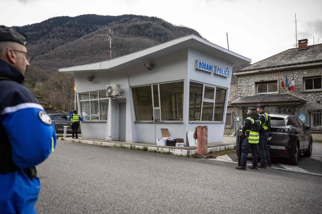 (FILES) French gendarmes check drivers crossing the French-Spanish border at the customs post in Fos, southern France, on March 19, 2025, during a control operation against drug trafficking, illegal immigration and the illegal importation of cigarettes and alcohol. On the A9 motorway, which runs along the Mediterranean coast from Spain, Narbonne customs officers, flashing their lights and blaring their sirens, pull over suspicious vehicles in search of cocaine traffickers who are increasingly crossing the Franco-Spanish border, where more than 65 percent of the drugs supplying France already transit. (Photo by Lionel BONAVENTURE / AFP)