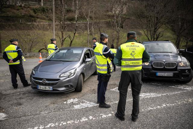 (FILES) French gendarmes and a Guardia Civil officer check drivers crossing the French-Spanish border in Fos, southern France, on March 19, 2025, during a control operation against drug trafficking, illegal immigration and the illegal importation of cigarettes and alcohol. On the A9 motorway, which runs along the Mediterranean coast from Spain, Narbonne customs officers, flashing their lights and blaring their sirens, pull over suspicious vehicles in search of cocaine traffickers who are increasingly crossing the Franco-Spanish border, where more than 65 percent of the drugs supplying France already transit. (Photo by Lionel BONAVENTURE / AFP)