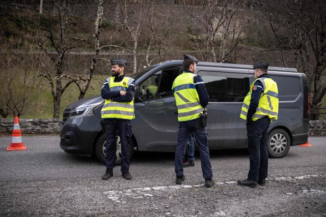 (FILES) French gendarmes check drivers crossing the French-Spanish border in Fos, southern France, on March 19, 2025, during a control operation against drug trafficking, illegal immigration and the illegal importation of cigarettes and alcohol. On the A9 motorway, which runs along the Mediterranean coast from Spain, Narbonne customs officers, flashing their lights and blaring their sirens, pull over suspicious vehicles in search of cocaine traffickers who are increasingly crossing the Franco-Spanish border, where more than 65 percent of the drugs supplying France already transit. (Photo by Lionel BONAVENTURE / AFP)