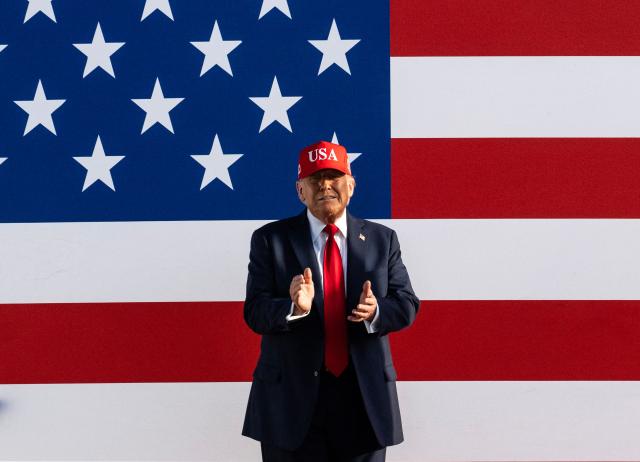 US President Donald Trump claps as he arrives to speak at the Salute to America Celebration at the Iowa State Fairgrounds in Des Moines on July 3, 2025. (Photo by ANDREW CABALLERO-REYNOLDS / AFP)