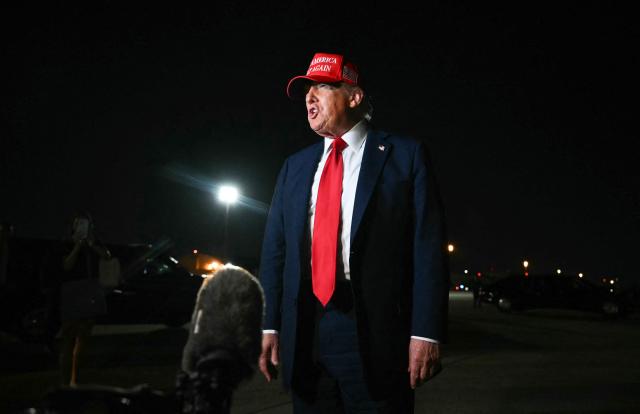 US President Donald Trump talks to journalists as he arrives at Joint Base Andrews, Maryland early on July 4, 2025. Trump returns from Iowa where he spoke at the Salute to America Celebration at the Iowa State Fairgrounds in Des Moines. (Photo by ANDREW CABALLERO-REYNOLDS / AFP)