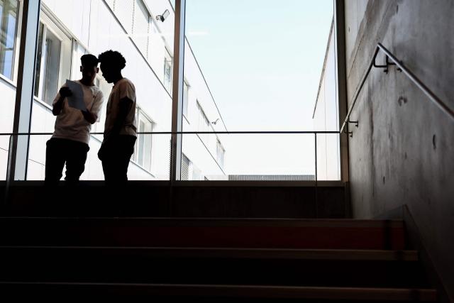 High school students react as they check the results of the baccalaureat exam (high school graduation exam) at a high school in Saint-Ouen, in the northern outskirts of Paris on July 4, 2025. (Photo by Thibaud MORITZ / AFP)