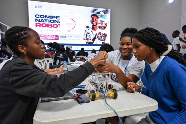 Young robotic enthusiasts take part in the first edition of the National Robotic Competition on July 3, 2025 in Abidjan. (Photo by Issouf SANOGO / AFP)
