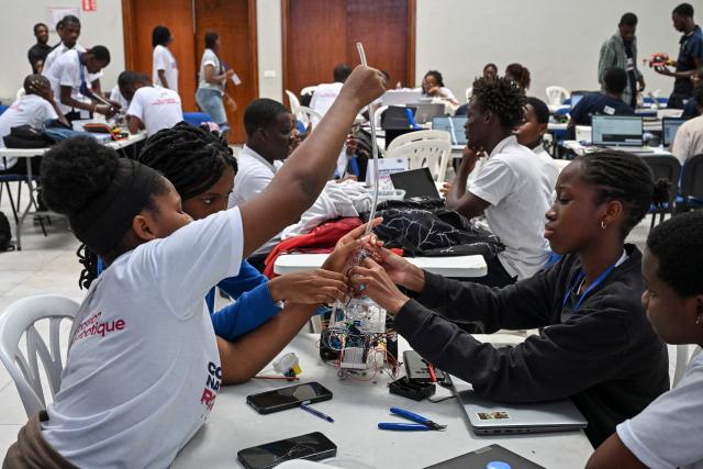 Young robotic enthusiasts take part in the first edition of the National Robotic Competition on July 3, 2025 in Abidjan. (Photo by Issouf SANOGO / AFP)