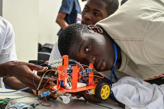 Young robotic enthusiasts take part in the first edition of the National Robotic Competition on July 3, 2025 in Abidjan. (Photo by Issouf SANOGO / AFP)