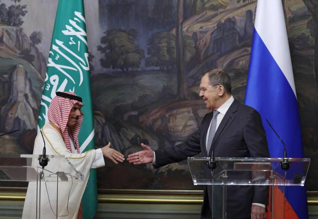 Russia's Foreign Minister Sergei Lavrov shakes hands with Saudi Arabia's Foreign Minister Prince Faisal bin Farhan Al Saud during a joint press conference following their meeting in Moscow on July 4, 2025. (Photo by Evgenia Novozhenina / POOL / AFP)