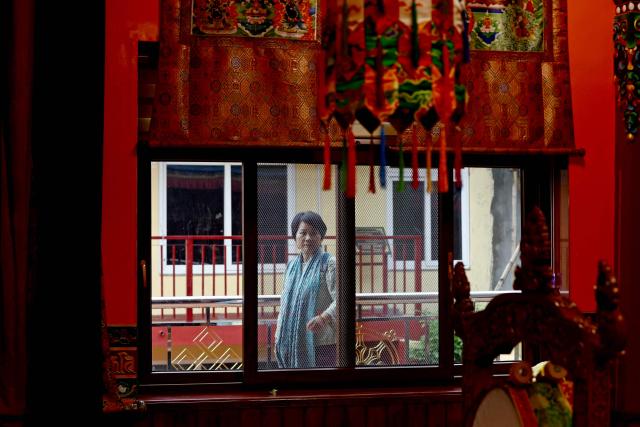A woman walks at Nechung Monastery in McLeodganj on July 4, 2025. (Photo by Niharika KULKARNI / AFP)