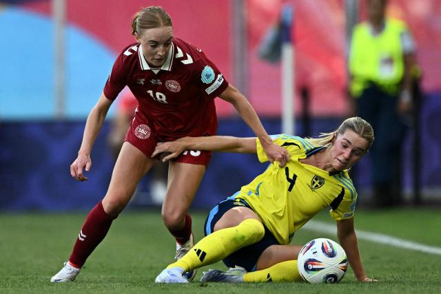 TOPSHOT - Denmark's defender #18 Sara Holmgaard fights for the ball with Sweden's defender #04 Hanna Lundkvist during the UEFA Women's Euro 2025 Group C football match between Denmark and Sweden at the Stade de Geneve in Geneva, on July 4, 2025. (Photo by Fabrice COFFRINI / AFP)