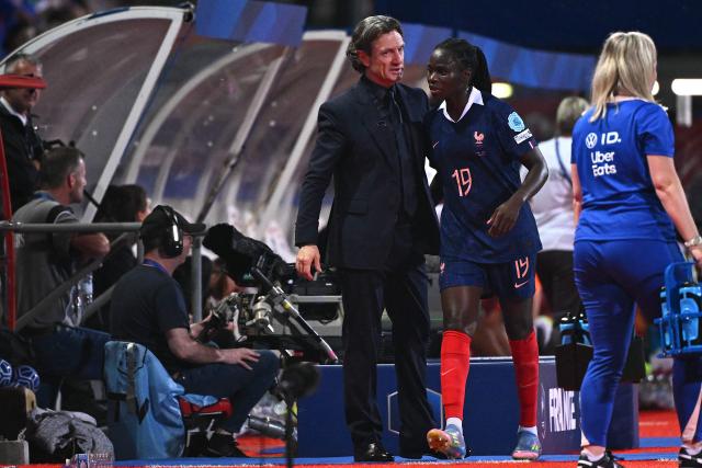(FILES) France’s head coach Laurent Bonadei (C) congratulates France’s defender #19 Griedge Mbock Bathy Nka during the UEFA Women's Nations League group A2 football match between France and Switzerland at the Marcel Picot stadium in Nancy, eastern France, on May 30, 2025. France captain Griedge Mbock is out of action against England on July 5, 2025 for Les Bleues' Euro-2025 opener after suffering a right calf injury, French coach Laurent Bonadei announced on July 4, 2025. (Photo by Sйbastien BOZON / AFP)