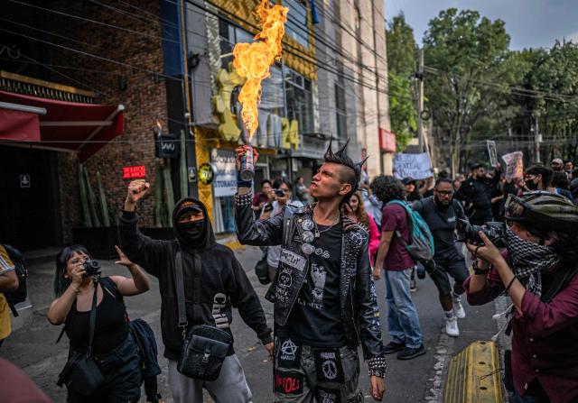 A protestor lights an aerosol can during a protest against gentrification in Mexico City on July 4, 2025. The protesters cited rising housing costs and the displacement of long-time Mexican residents from areas of the city that have received large numbers of foreigners. (Photo by Carl de Souza / AFP)