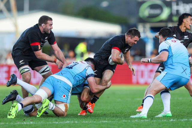 New Zealand Maori's Kurt Eklund (2nd-R) gets tackled by Scotlands Marshall Sykes (C) during their rugby match between New Zealand Maori and Scotland at Semenoff Stadium in Whangarei on July 5, 2025. (Photo by DJ Mills / AFP)