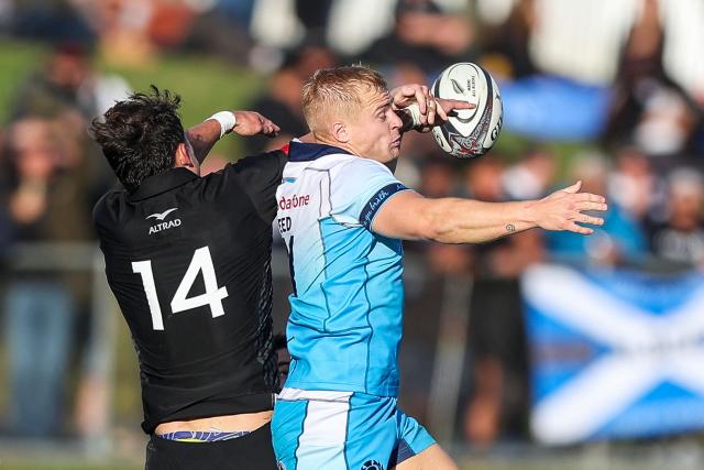 New Zealand Maori's Cole Forbes (L) and Scotland's Arron Reed (R) challenge for the ball during their rugby match between New Zealand Maori and Scotland at Semenoff Stadium in Whangarei on July 5, 2025. (Photo by DJ Mills / AFP)