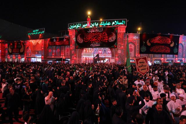 Shiite Muslim worshippers walk in a procession towards the Imam Hussein Shrine during a mourning ritual on the ninth day of the Muslim month of Muharram, in the lead-up to Ashura, a 10-day period commemorating the seventh century killing of Prophet Mohammed's grandson Imam Hussein, in the holy city of Karbala in southern Iraq on July 4, 2025. (Photo by AHMAD AL-RUBAYE / AFP)