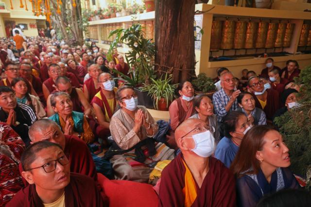 Exiled Tibetans attend a long-life prayer offering ceremony led by Tibetan spiritual leader the Dalai Lama at the Main Tibetan Temple in McLeod Ganj, near Dharamsala on July 5, 2025. The Dalai Lama said on July 5 he dreamed of living for decades more, as the Buddhist spiritual leader prayed with thousands of exiled Tibetans on the eve of his 90th birthday. (Photo by Sanjay BAID / AFP)