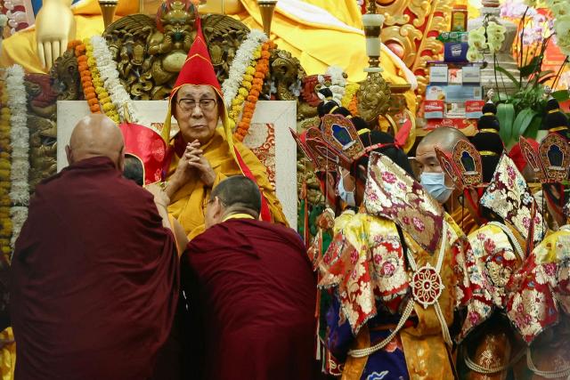 Tibetan spiritual leader the Dalai Lama (L, back) attends a long-life prayer offering ceremony at the Main Tibetan Temple in McLeod Ganj, near Dharamsala on July 5, 2025. The Dalai Lama said on July 5 he dreamed of living for decades more, as the Buddhist spiritual leader prayed with thousands of exiled Tibetans on the eve of his 90th birthday. (Photo by Niharika KULKARNI / AFP)