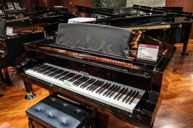 Yamaha pianos are seen on display at a showroom in Tokyo on July 5, 2025. (Photo by Yuichi YAMAZAKI / AFP)
