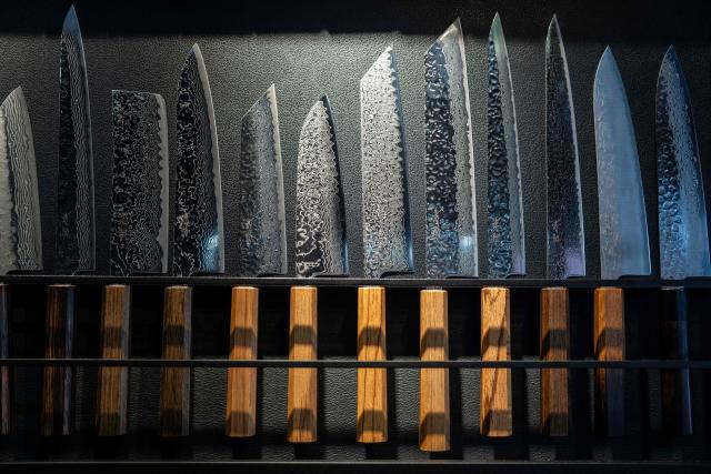 Japanese knives are seen on display at a store in Tokyo on July 5, 2025. (Photo by Yuichi YAMAZAKI / AFP)