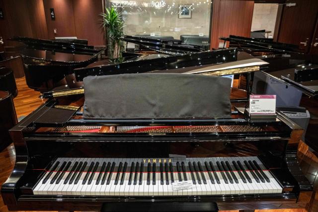 Yamaha pianos are seen on display at a showroom in Tokyo on July 5, 2025. (Photo by Yuichi YAMAZAKI / AFP)
