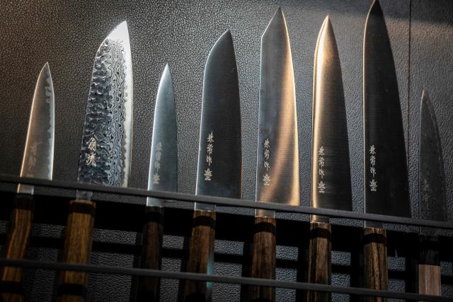 Japanese knives are seen on display at a store in Tokyo on July 5, 2025. (Photo by Yuichi YAMAZAKI / AFP)