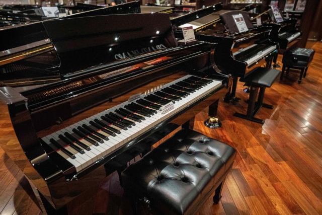 Yamaha pianos are seen on display at a showroom in Tokyo on July 5, 2025. (Photo by Yuichi YAMAZAKI / AFP)