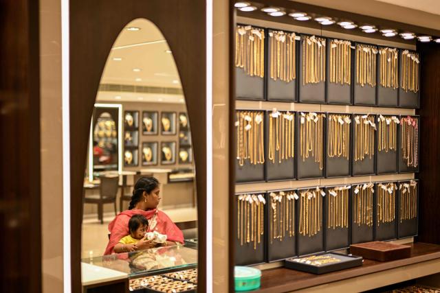 A woman waits to buy gold ornaments at a jewellery store in Chennai on July 5, 2025. New Delhi and Washington have been locked in multiple rounds of talks, with hopes for an interim pact to avert the 26 percent "reciprocal" tolls meted out to India. (Photo by R. Satish BABU / AFP)