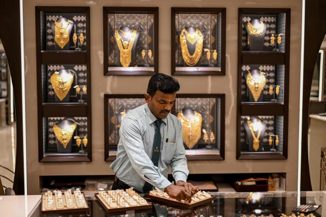A salesman arranges gold chains at a jewellery store in Chennai on July 5, 2025. New Delhi and Washington have been locked in multiple rounds of talks, with hopes for an interim pact to avert the 26 percent "reciprocal" tolls meted out to India. (Photo by R. Satish BABU / AFP)