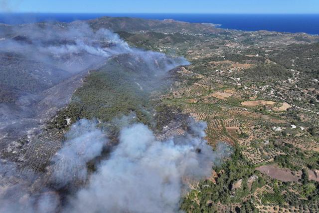 An aerial view shows smoke billowing from a forest fire in the coastal Syrian province of Latakia on July 5, 2025. Syrian emergency workers were battling forest fires raging in the coastal province of Latakia on Saturday for a third day in tough conditions as neighbouring Turkey sent assistance. Syria's ministry for emergencies and disaster management said teams from Turkey began helping on Saturday morning "as part of regional coordination to face the fires", with the assistance including two aircrafts and eight fire trucks. (Photo by OMAR HAJ KADOUR / AFP)