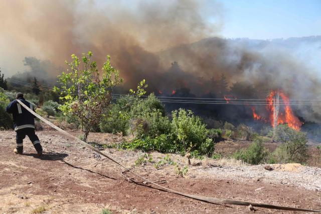 Syrian firefighters battle a forest fire in the coastal Syrian province of Latakia on July 5, 2025. Syrian emergency workers were battling forest fires raging in the coastal province of Latakia on Saturday for a third day in tough conditions as neighbouring Turkey sent assistance. Syria's ministry for emergencies and disaster management said teams from Turkey began helping on Saturday morning "as part of regional coordination to face the fires", with the assistance including two aircrafts and eight fire trucks. (Photo by OMAR HAJ KADOUR / AFP)