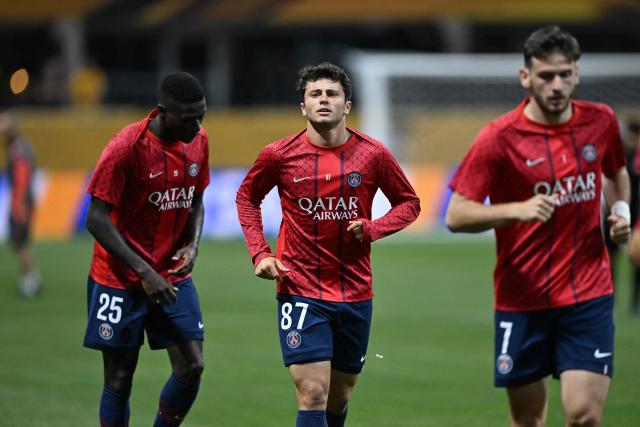 Paris Saint-Germain's Portuguese midfielder #87 Joao Pedro Goncalves Neves (C) and teammates warm up before the FIFA Club World Cup 2025 quarterfinal football match between France's Paris Saint-Germain and Germany's Bayern Munich at the Mercedes-Benz Stadium in Atlanta on July 5, 2025. (Photo by PATRICIA DE MELO MOREIRA / AFP)