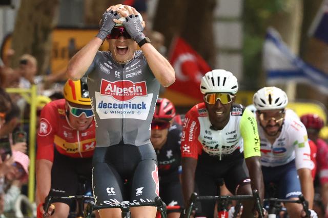 Alpecin - Deceuninck team's Belgian rider Jasper Philipsen (C) cycles to the finish line to win the 1st stage ahead of Intermarch - Wanty team's Eritrean rider Biniam Girmay (2nd R) and Uno-X Mobility team's Norwegian rider Soren Waerenskjold (L) the 112th edition of the Tour de France cycling race, 184.9 km starting and finishing in Lille Metropole, northern France, on July 5, 2025. (Photo by Anne-Christine POUJOULAT / AFP)