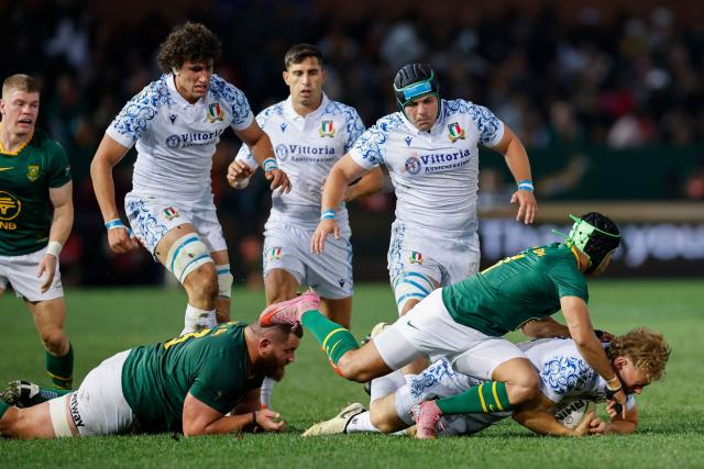 South Africa's wing Kurt-Lee Arendse (2nd R) tackles Italy's wing Louis Lynagh (R) during the international rugby union Test match between South Africa and Italy at Loftus Versfeld stadium in Pretoria on July 5, 2025. (Photo by PHILL MAGAKOE / AFP)