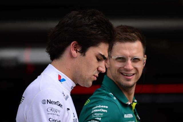 Aston Martin's Canadian driver Lance Stroll (L) walks back during the qualifying session ahead of the Formula One British Grand Prix at the Silverstone motor racing circuit in Silverstone, central England, on July 5, 2025. (Photo by Ben STANSALL / POOL / AFP)