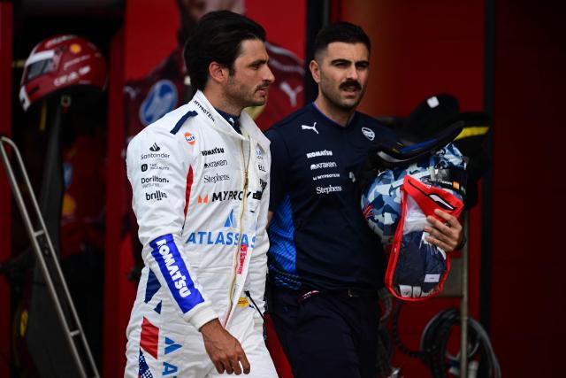Williams' Spanish driver Carlos Sainz (L) walks back during the qualifying session ahead of the Formula One British Grand Prix at the Silverstone motor racing circuit in Silverstone, central England, on July 5, 2025. (Photo by Ben STANSALL / POOL / AFP)