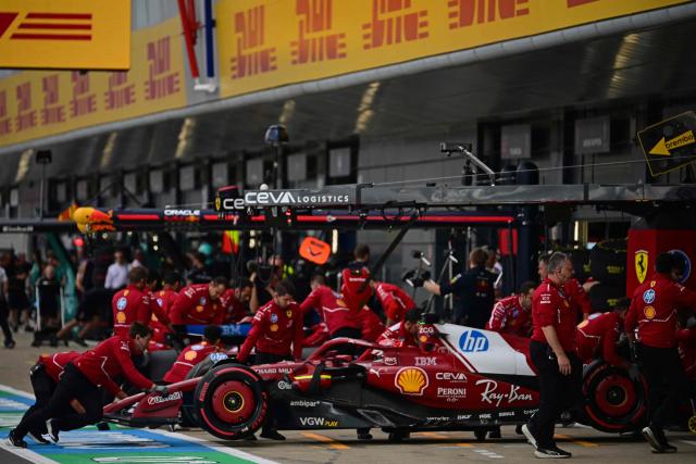 The Ferrari of Monegasque driver Charles Leclerc is pushed back into the garage during the qualifying session ahead of the Formula One British Grand Prix at the Silverstone motor racing circuit in Silverstone, central England, on July 5, 2025. (Photo by Ben STANSALL / POOL / AFP)