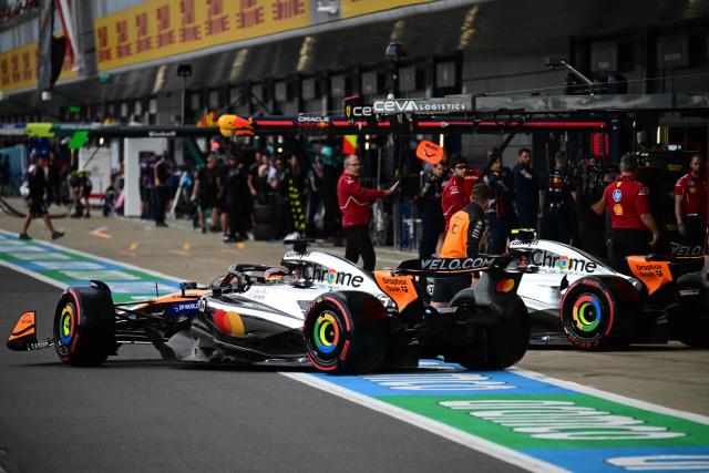 McLaren's Australian driver Oscar Piastri (L) and McLaren's British driver Lando Norris (R) leave their garage during the qualifying session ahead of the Formula One British Grand Prix at the Silverstone motor racing circuit in Silverstone, central England, on July 5, 2025. (Photo by Ben STANSALL / POOL / AFP)