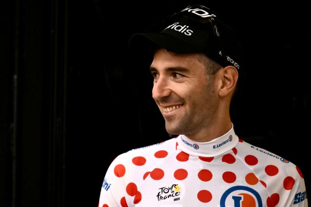 Cofidis team's French rider Benjamin Thomas celebrates on the podium with the best climber's polka dot (dotted) jersey after the 1st stage of the 112th edition of the Tour de France cycling race, 184.9 km starting and finishing in Lille Metropole, northern France, on July 5, 2025. (Photo by Marco BERTORELLO / AFP)