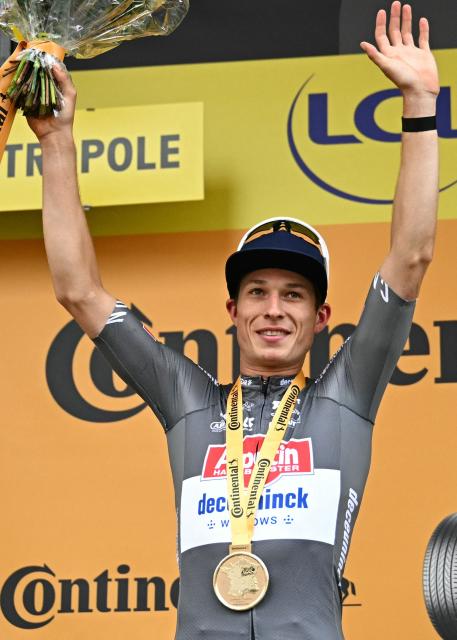 Alpecin - Deceuninck team's Belgian rider Jasper Philipsen celebrates on the podium after winning the 1st stage of the 112th edition of the Tour de France cycling race, 184.9 km starting and finishing in Lille Metropole, northern France, on July 5, 2025. (Photo by Loic VENANCE / AFP)