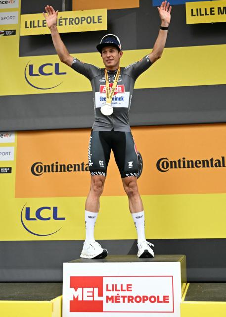 Alpecin - Deceuninck team's Belgian rider Jasper Philipsen celebrates on the podium after winning the 1st stage of the 112th edition of the Tour de France cycling race, 184.9 km starting and finishing in Lille Metropole, northern France, on July 5, 2025. (Photo by Loic VENANCE / AFP)