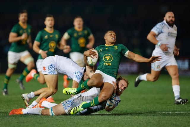 South Africa's fullback Damian Willemse (C top) is tackled by Italy's lock Niccolo Cannone (below) during the international rugby union Test match between South Africa and Italy at Loftus Versfeld stadium in Pretoria on July 5, 2025. (Photo by PHILL MAGAKOE / AFP)