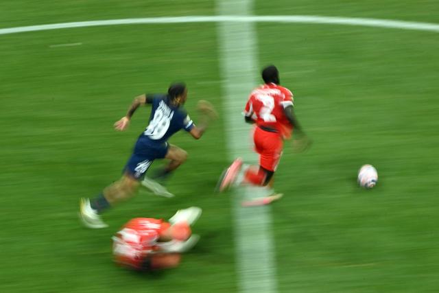 This slow shutter speed photograph shows Bayern Munich's French defender #02 Dayot Upamecano and Paris Saint-Germain's French forward #29 Bradley Barcola fighting for the ball during the FIFA Club World Cup 2025 quarterfinal football match between France's Paris Saint-Germain and Germany's Bayern Munich at the Mercedes-Benz Stadium in Atlanta on July 5, 2025. (Photo by ROBERTO SCHMIDT / AFP)