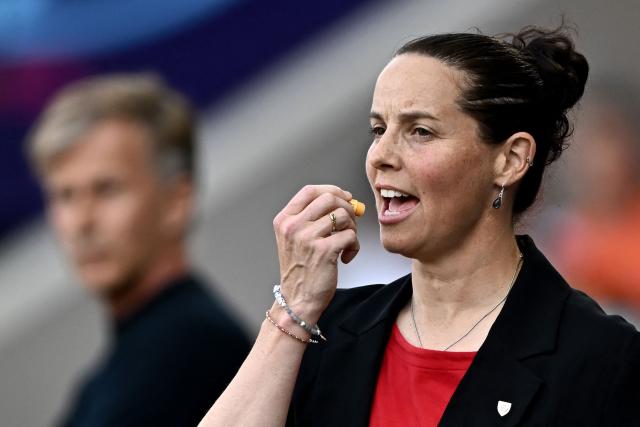 Wales' coach Rhian Wilkinson applies lip balm during the UEFA Women's Euro 2025 Group D football match between Wales and The Netherlands at the Allmend Stadion Luzern in Lucerne on July 5, 2025. (Photo by Fabrice COFFRINI / AFP)