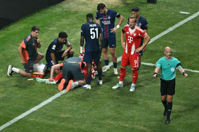 Paris Saint-Germain's players watch Bayern Munich's German midfielder #42 Jamal Musiala lying on the ground during the FIFA Club World Cup 2025 quarterfinal football match between France's Paris Saint-Germain and Germany's Bayern Munich at the Mercedes-Benz Stadium in Atlanta on July 5, 2025. (Photo by ROBERTO SCHMIDT / AFP)