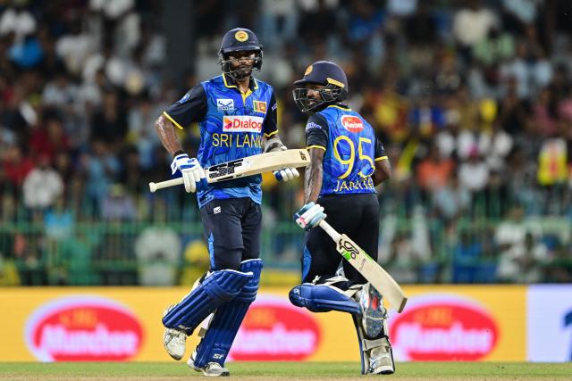 Sri Lanka's Janith Liyanage (R) and Dushmantha Chameera (L) run between the wickets during the second one-day international (ODI) cricket match between Sri Lanka and Bangladesh at the R. Premadasa International Cricket Stadium in Colombo on July 5, 2025. (Photo by Ishara S. KODIKARA / AFP)