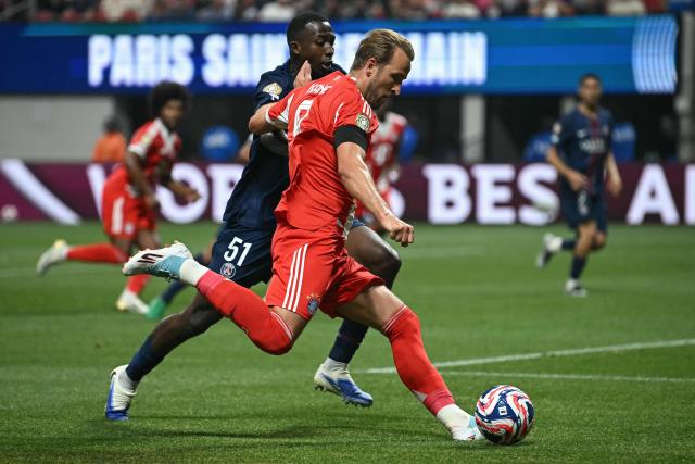 Bayern Munich's English forward #09 Harry Kane kicks the ball past Paris Saint-Germain's Ecuadorian defender #51 William Pacho during the FIFA Club World Cup 2025 quarterfinal football match between France's Paris Saint-Germain and Germany's Bayern Munich at the Mercedes-Benz Stadium in Atlanta on July 5, 2025. (Photo by Paul ELLIS / AFP)